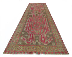 A vintage Persian Ardabil runner rug featuring a geometric pink and brown floral pattern.