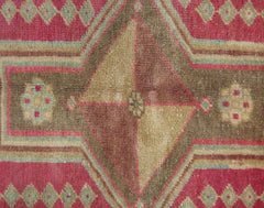 A vintage Persian Ardabil rug featuring a central diamond motif in shades of brown and tan.