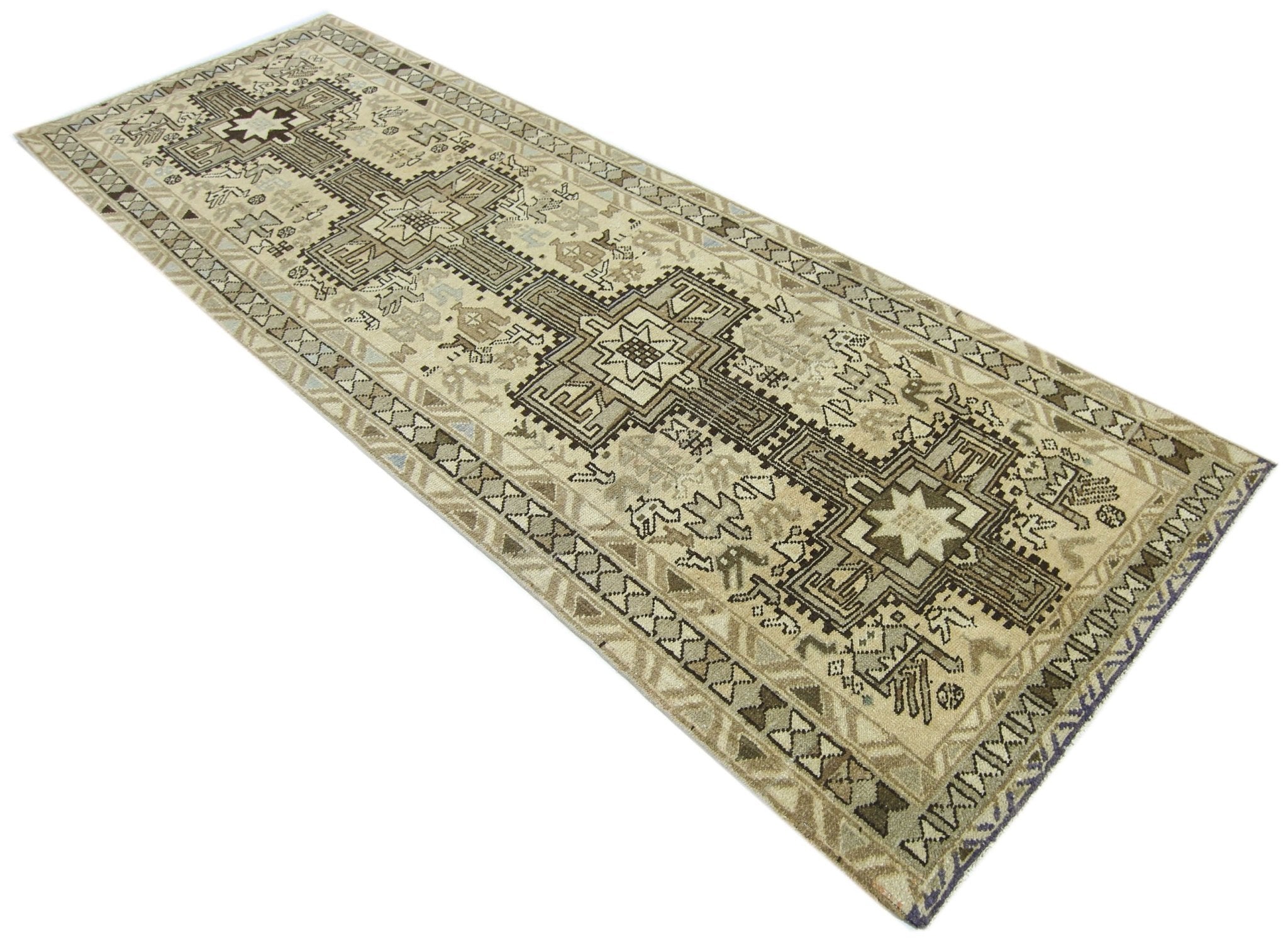 A vintage Persian Ardabil runner featuring geometric medallions in neutral earth tones.