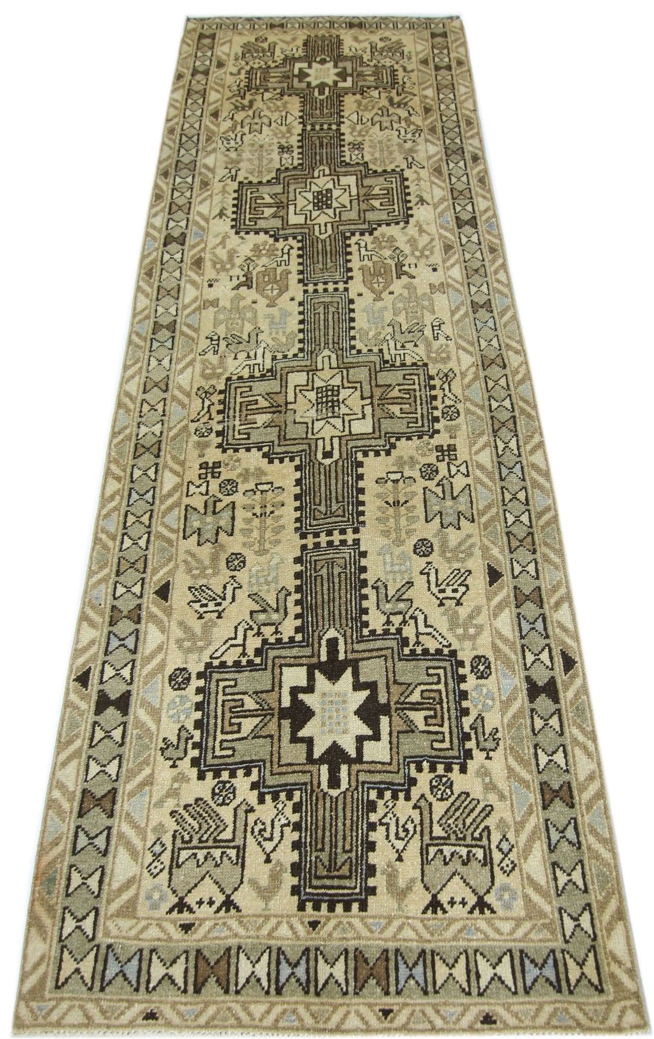 A vintage Persian Ardabil runner featuring geometric patterns and bird motifs in neutral tones.