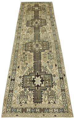 A vintage Persian Ardabil runner featuring geometric patterns and bird motifs in neutral tones.