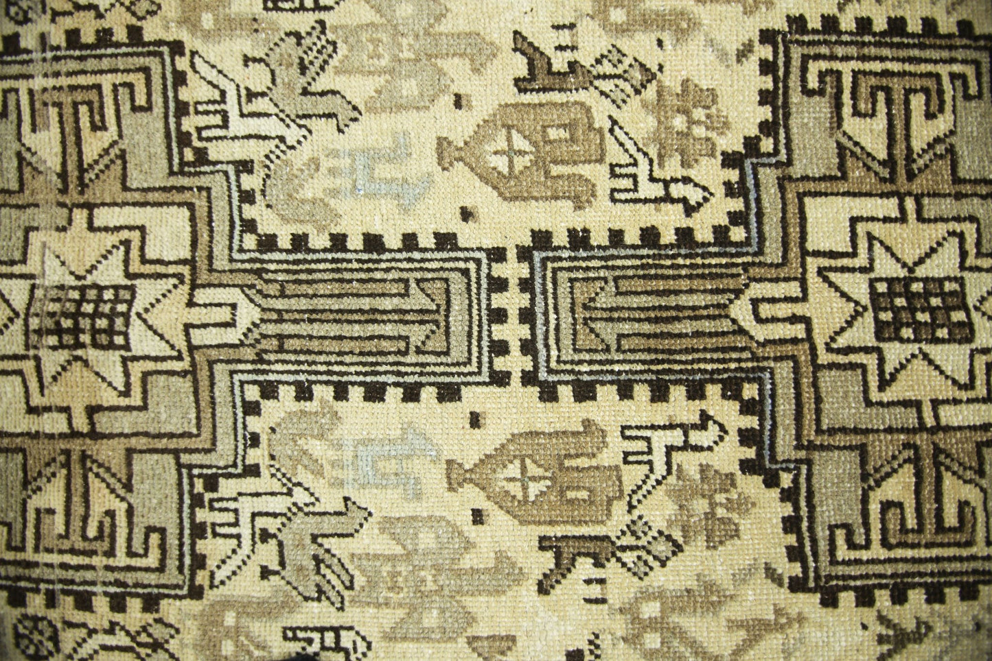 A vintage Persian Ardabil runner featuring intricate geometric patterns in shades of brown and cream.