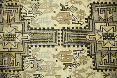 A vintage Persian Ardabil runner featuring intricate geometric patterns in shades of brown and cream.