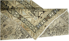 A vintage Persian Ardabil runner featuring a geometric pattern in neutral earth tones.