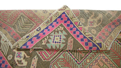 A vintage Persian Ardabil runner featuring geometric patterns in pink, purple, and green wool.