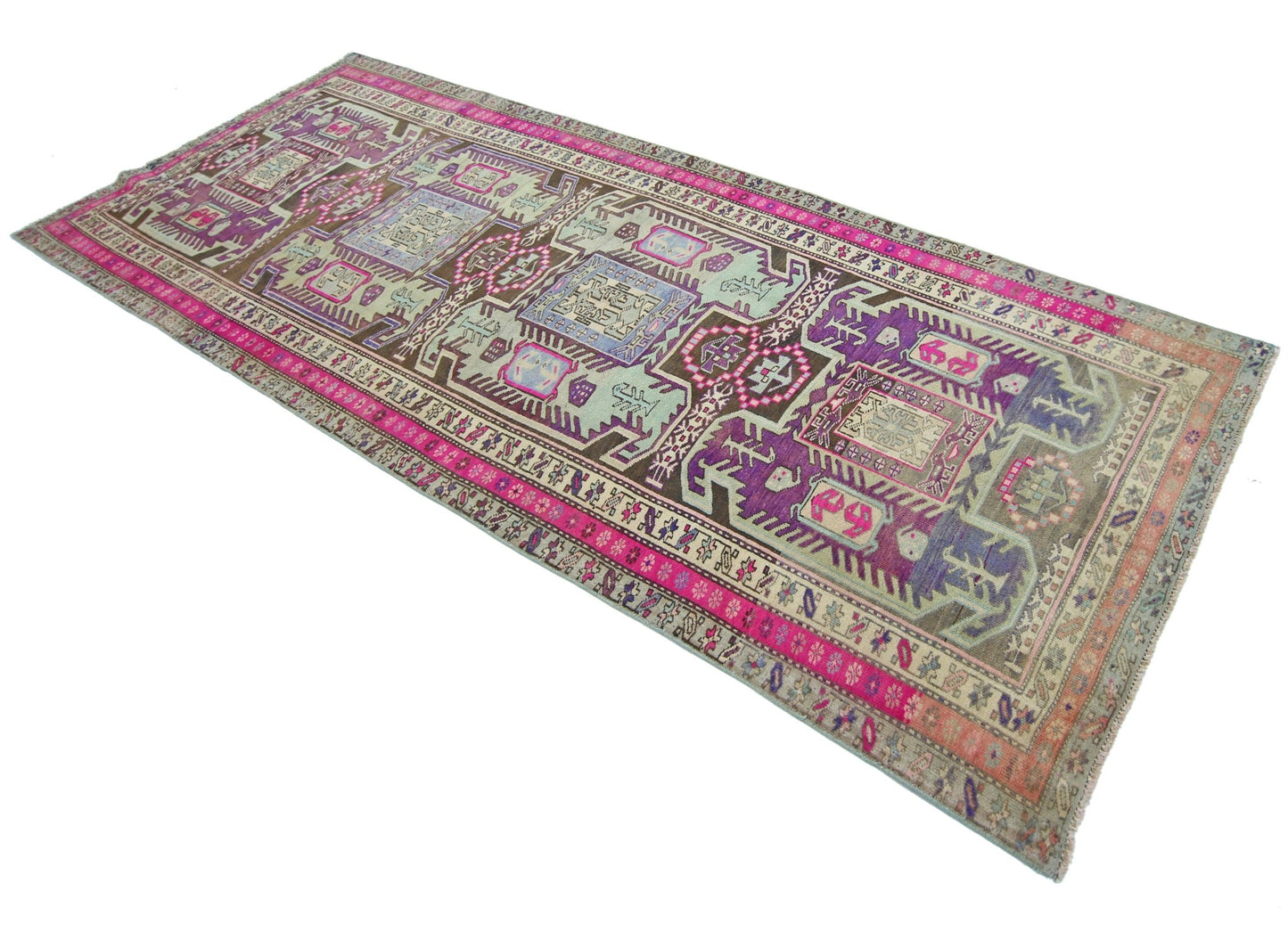 A vintage Persian Ardabil runner featuring a geometric pattern in vibrant purple, pink, and brown.