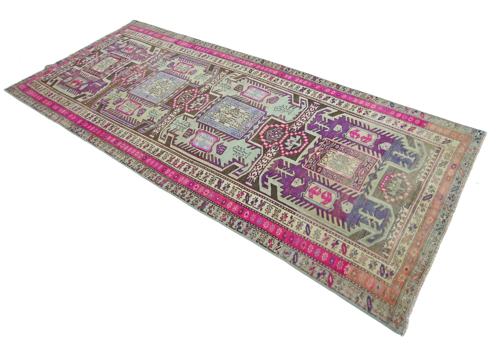 A vintage Persian Ardabil runner featuring a geometric pattern in vibrant purple, pink, and brown.