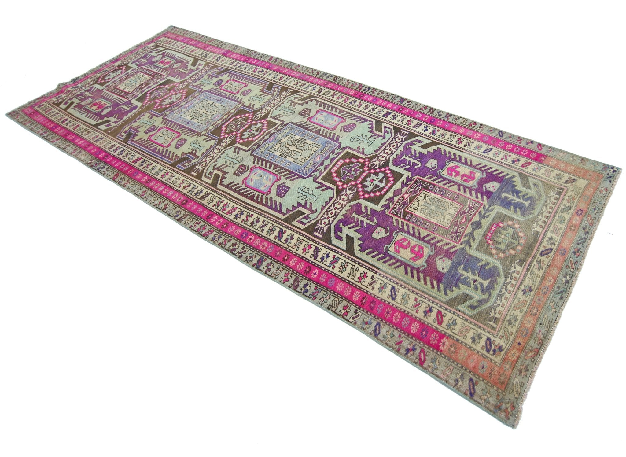 A vintage Persian Ardabil runner featuring a geometric pattern in vibrant purple, pink, and brown.
