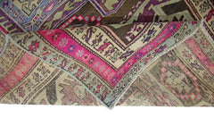 A vintage Persian Ardabil runner featuring a geometric pattern in vibrant pink, brown, and blue.