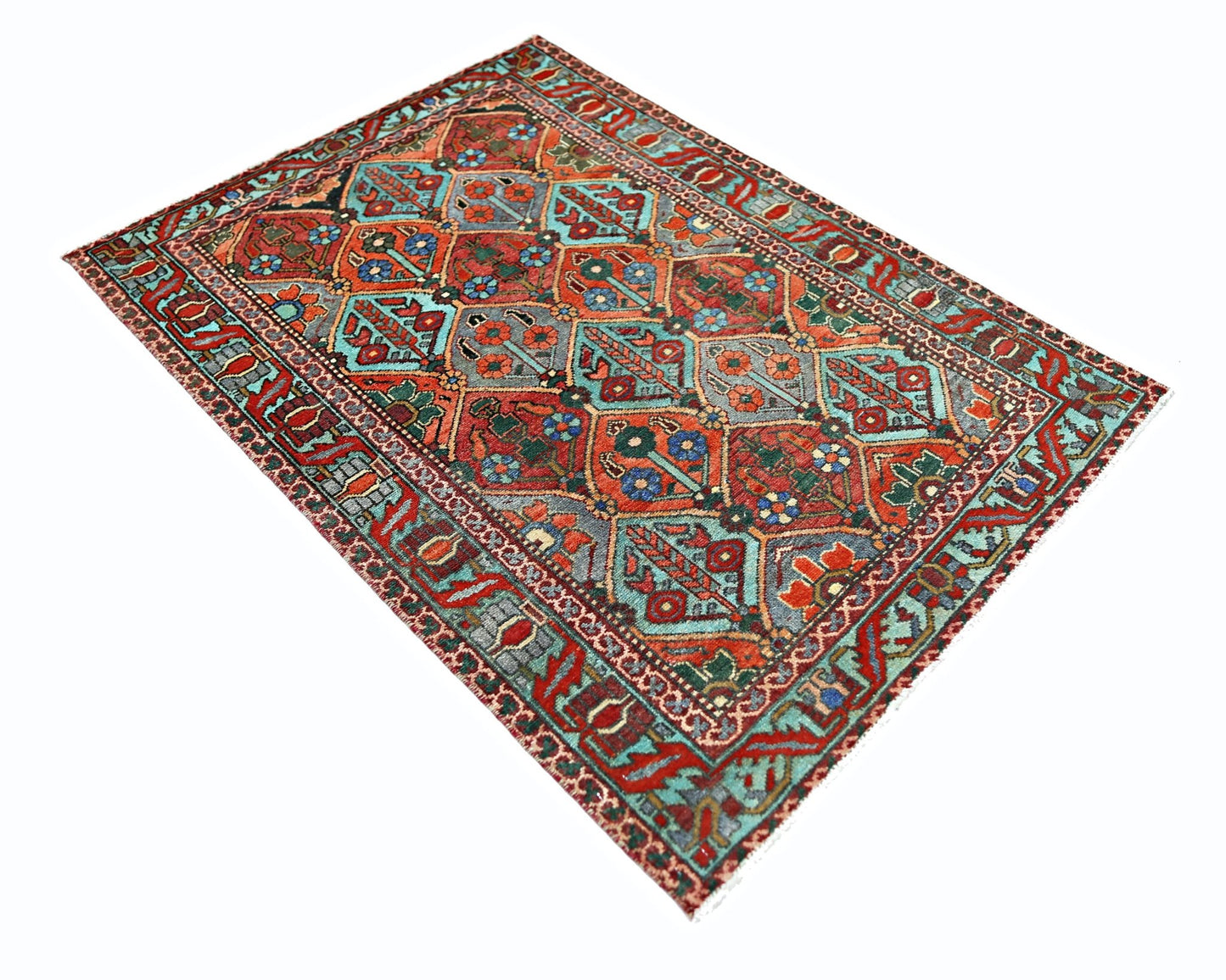A vintage Persian Bakhtiari rug featuring a geometric floral pattern in red, blue, and green.