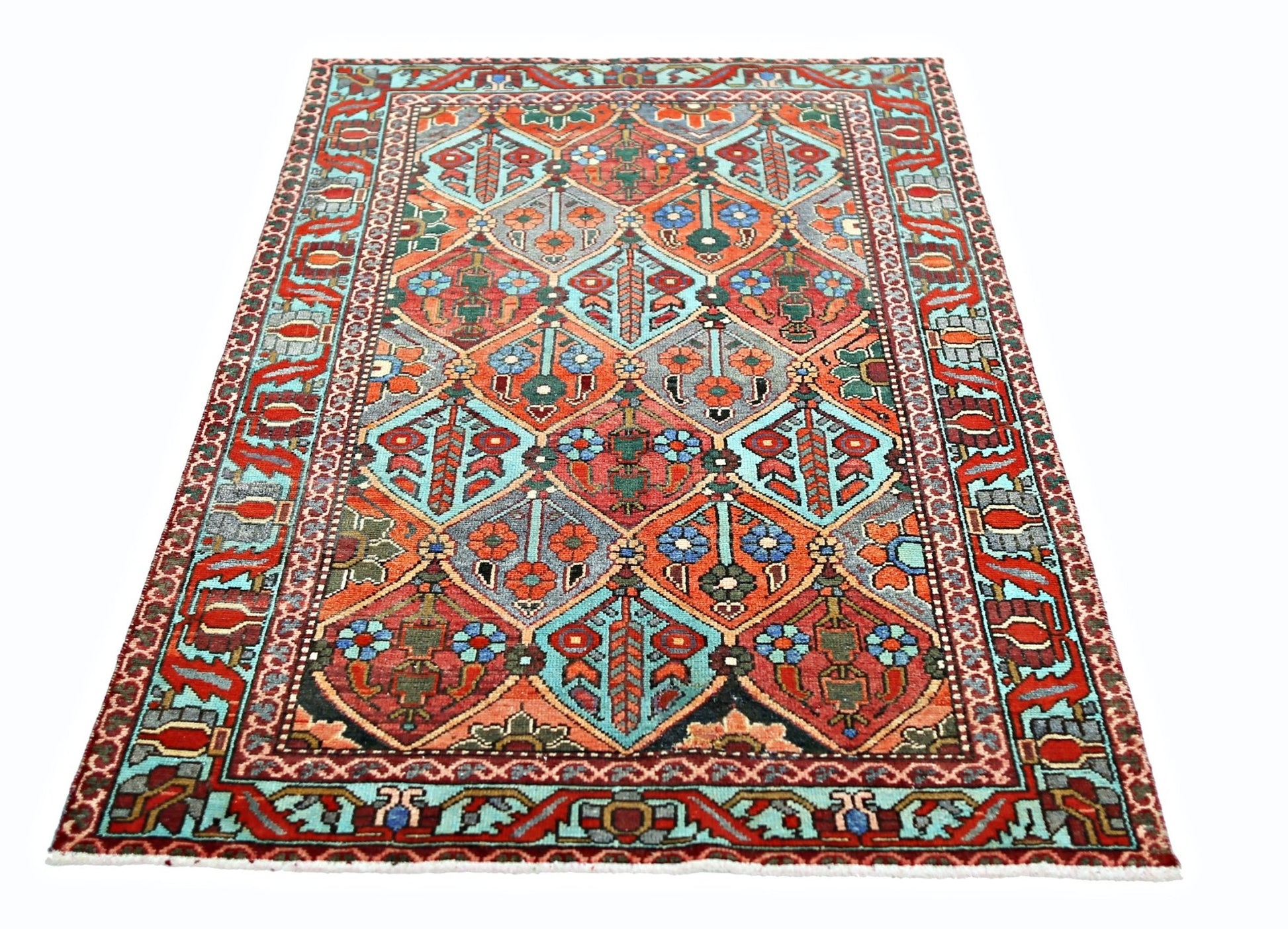 A vintage Persian Bakhtiari rug featuring a colorful geometric diamond pattern on a wool pile.