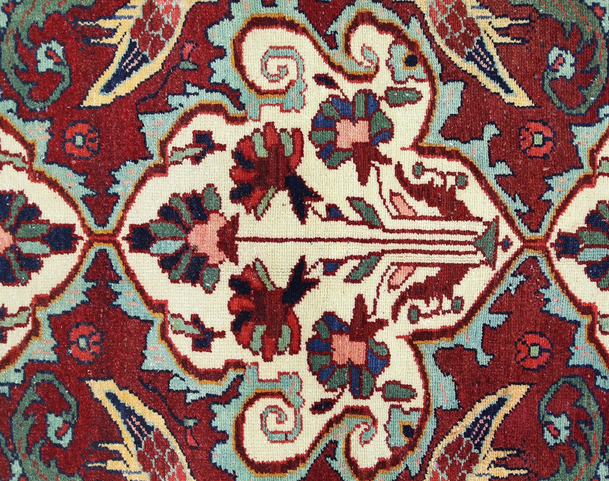 A vintage Persian Bakhtiari rug featuring a detailed floral pattern in red, cream, and blue tones.