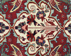 A vintage Persian Bakhtiari rug featuring a detailed floral pattern in red, cream, and blue tones.