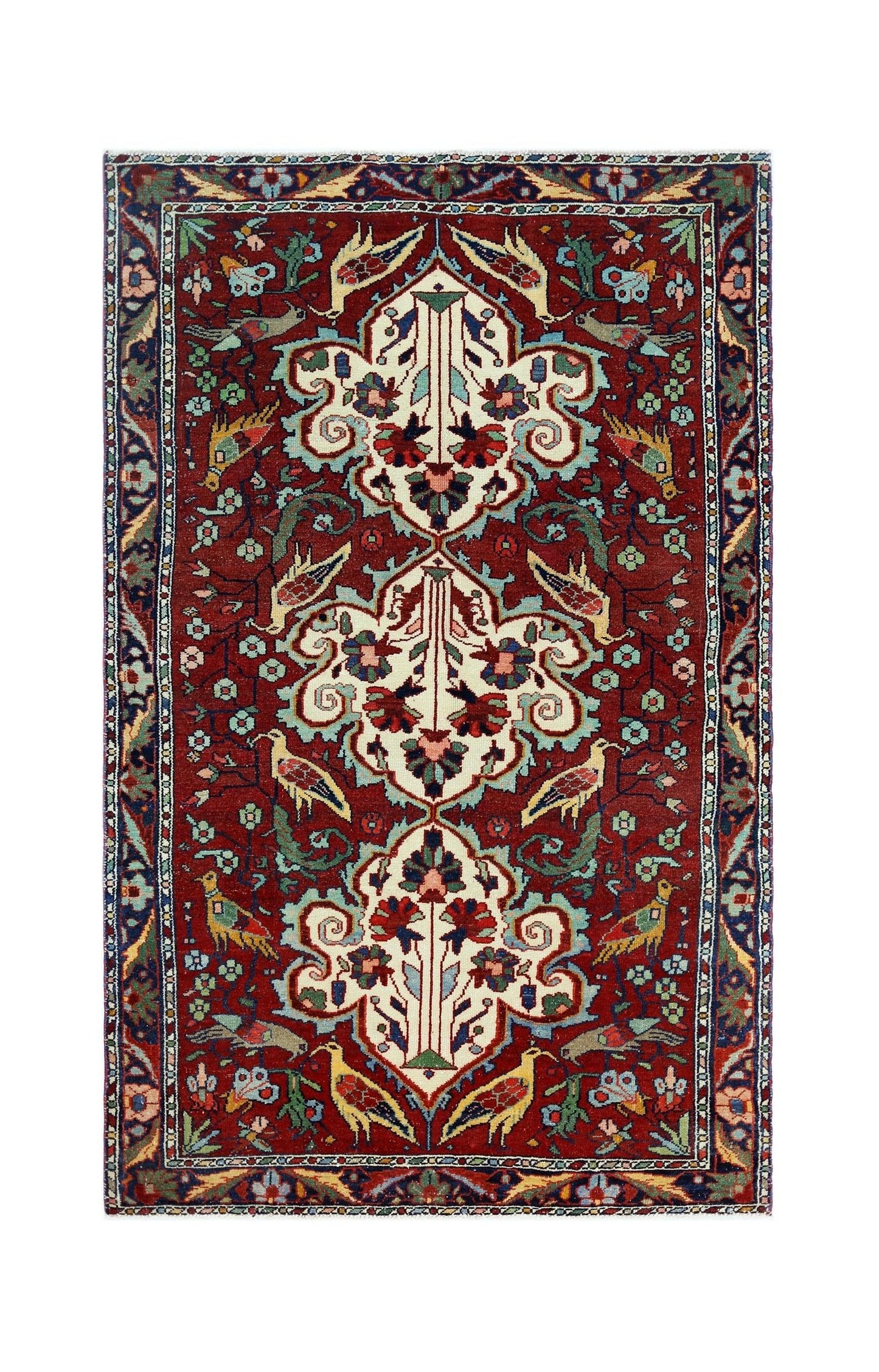 A vintage Persian Bakhtiari rug featuring a red field with floral motifs and bird patterns.