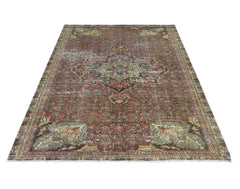 A vintage handmade Persian Bakhtiari rug featuring a traditional floral medallion in muted tones.