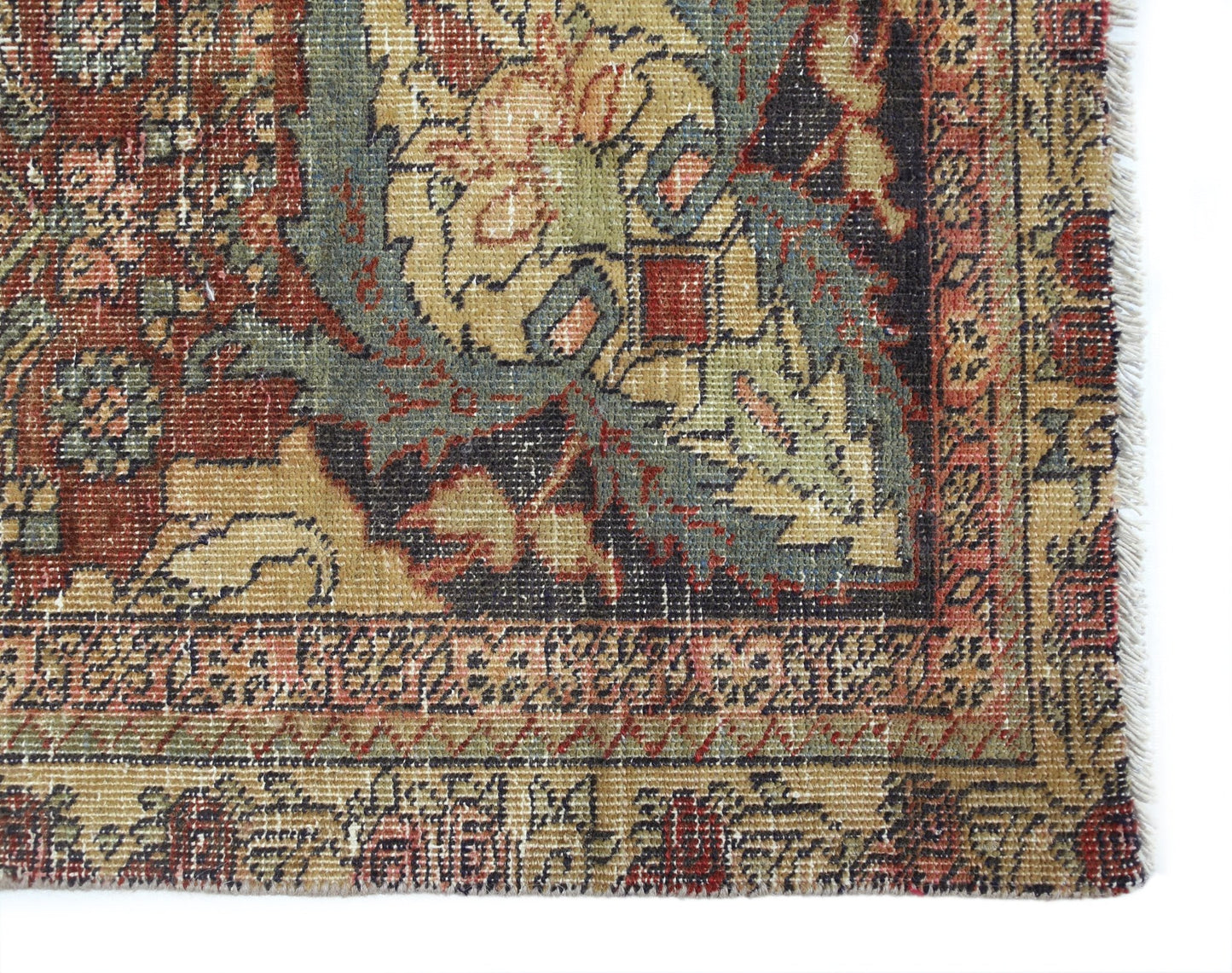 A vintage Persian Bakhtiari rug featuring intricate floral patterns in red, blue, and tan tones.