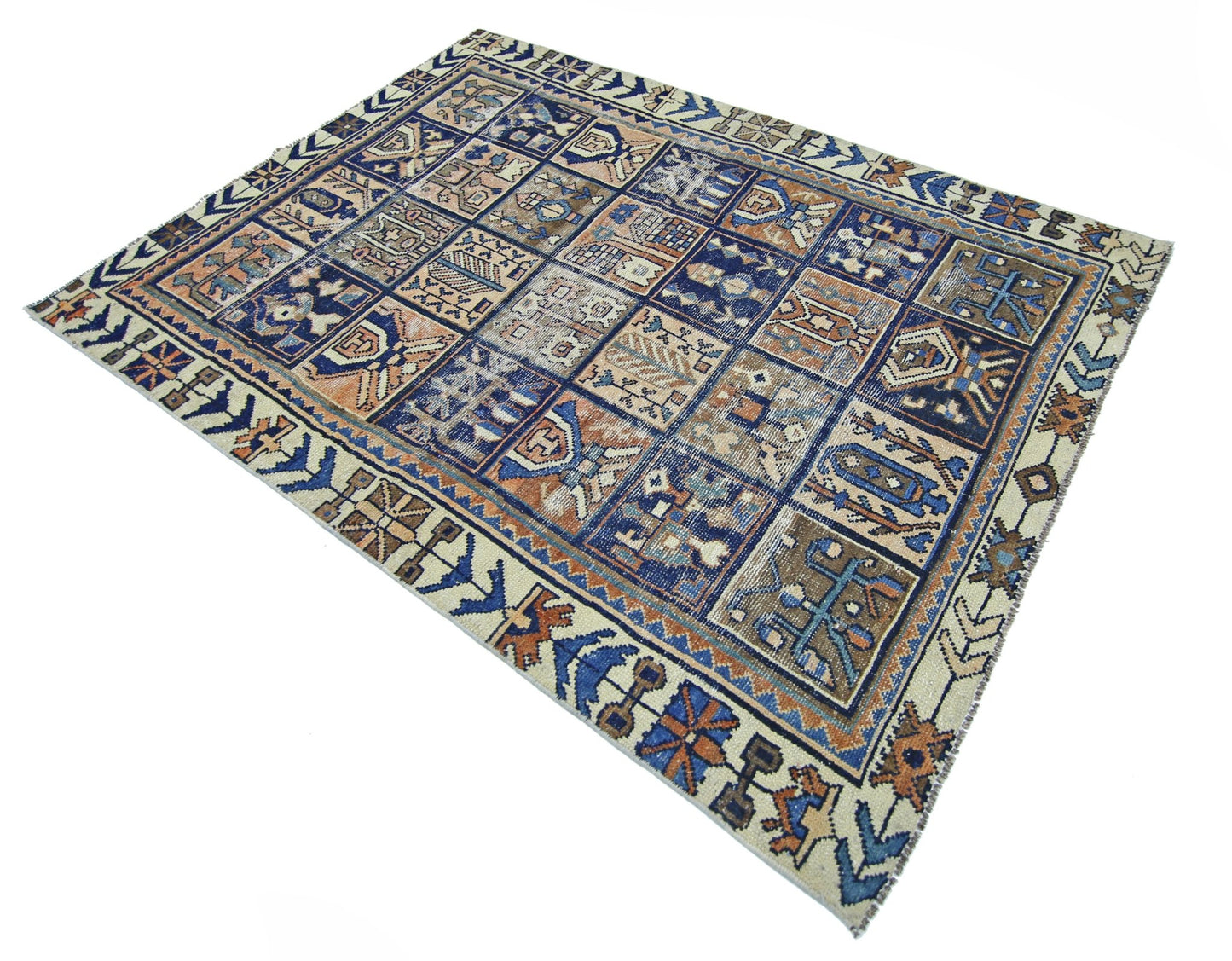 A vintage Persian Bakhtiari rug featuring a geometric grid pattern in blue, brown, and cream tones.