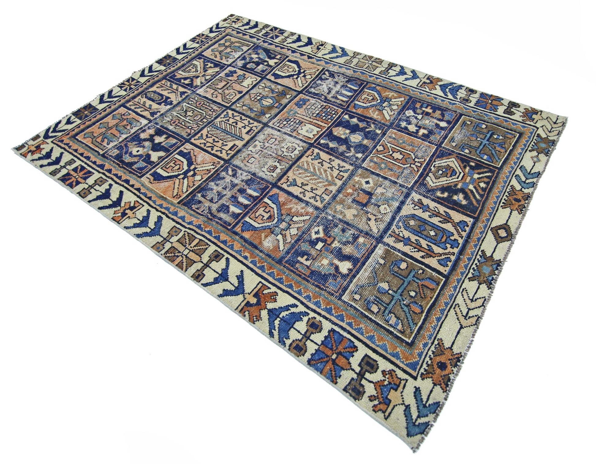 A vintage Persian Bakhtiari rug featuring a geometric grid pattern in blue, brown, and cream tones.