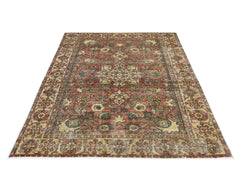 A vintage Persian Bakhtiari rug featuring a traditional floral pattern in red, green, and beige.