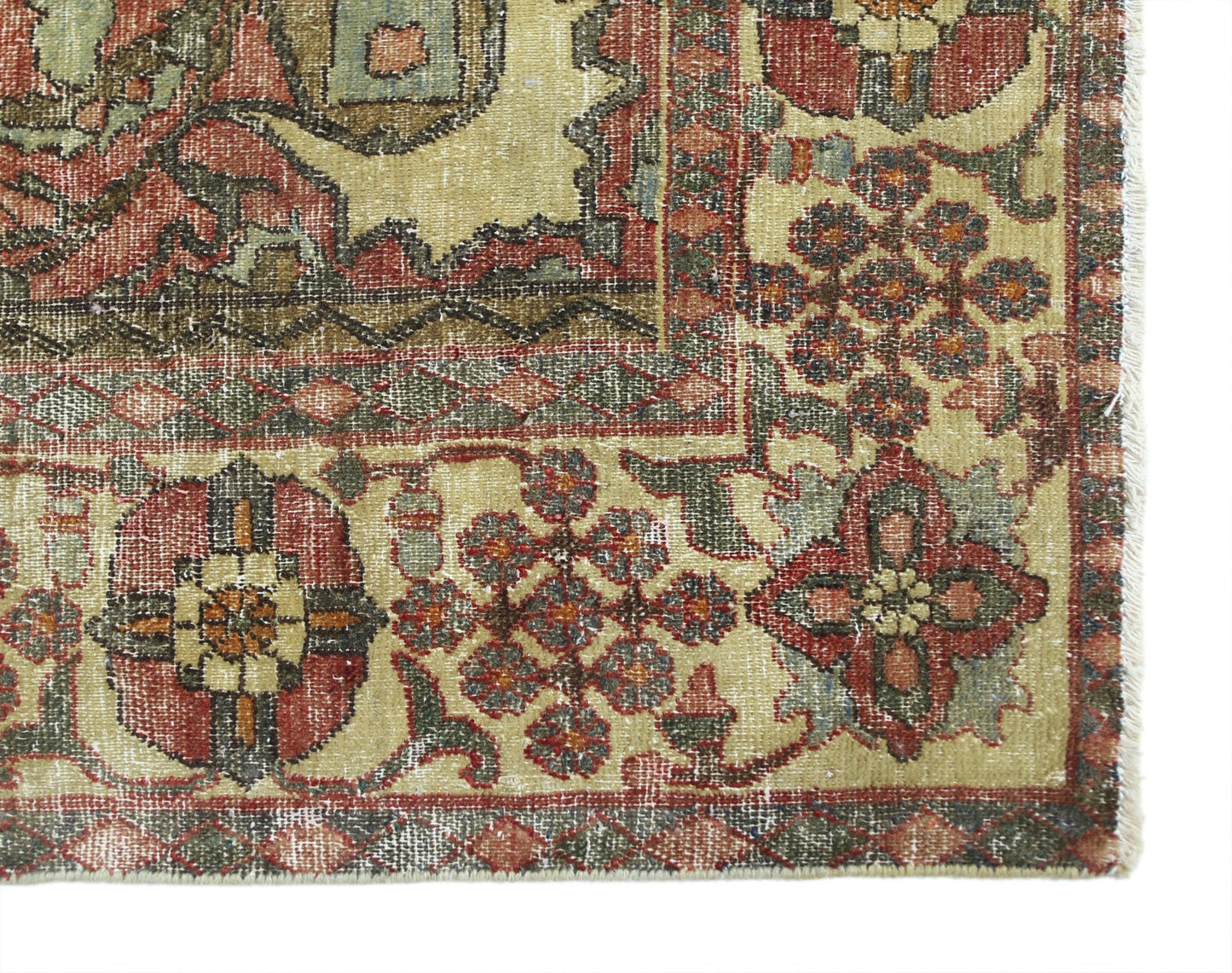 A vintage Persian Bakhtiari rug featuring intricate floral patterns in red, green, and cream tones.