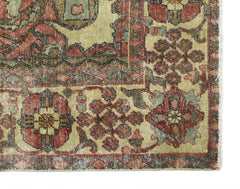 A vintage Persian Bakhtiari rug featuring intricate floral patterns in red, green, and cream tones.