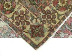 A vintage handmade Persian Bakhtiari rug featuring intricate floral patterns in red and green.