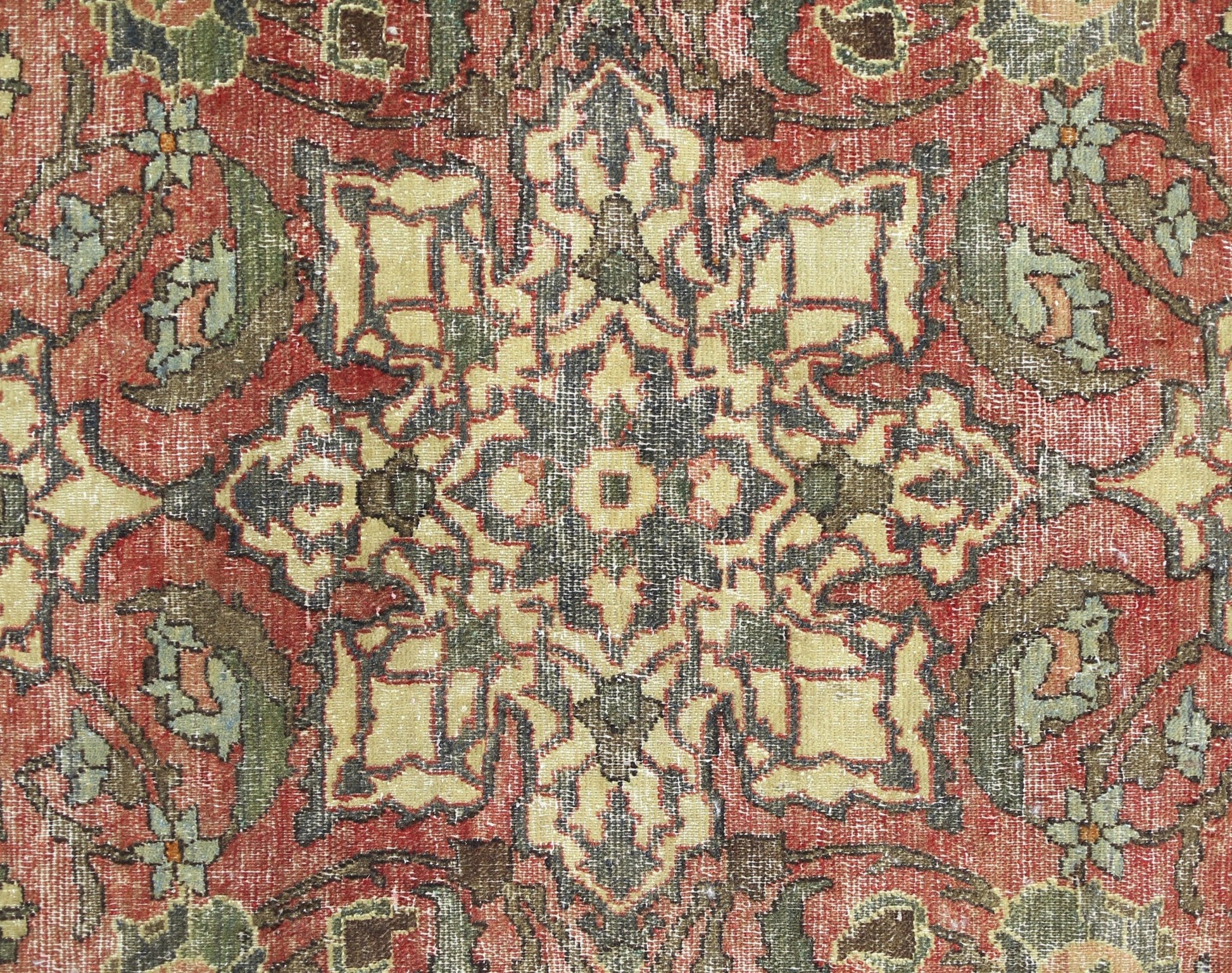 A vintage Persian Bakhtiari rug featuring a detailed geometric floral pattern in red and green.