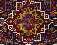 A vintage Persian Bakhtiari rug featuring a geometric central medallion in red, blue, and gold.
