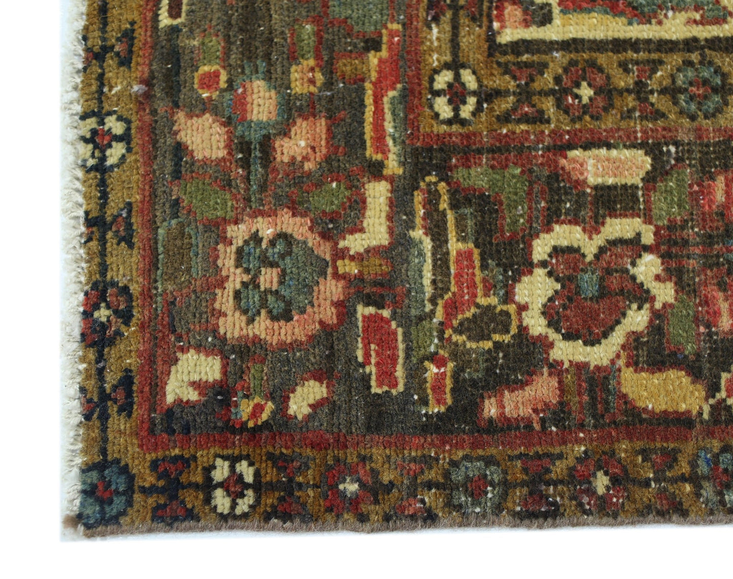 A corner view of a vintage Persian Bakhtiari rug featuring intricate floral patterns in wool.
