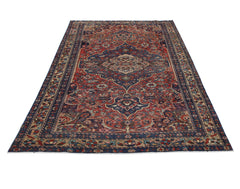 A vintage handmade Persian Bakhtiari rug featuring a traditional floral medallion on a red field.