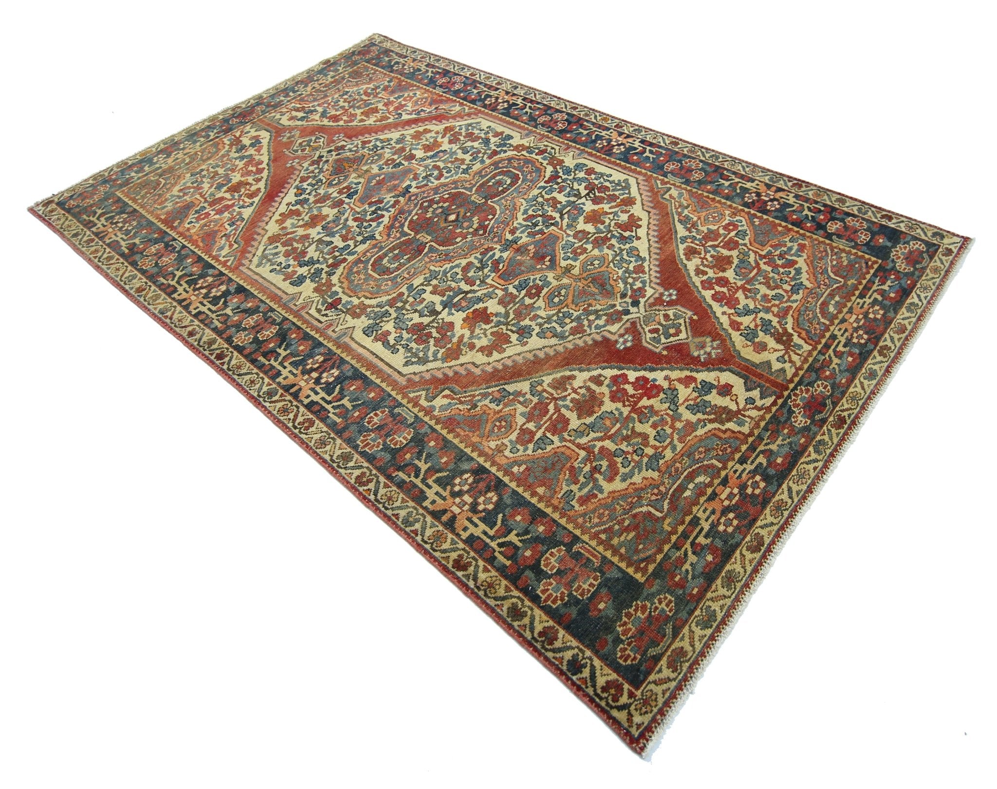 A vintage Persian Bakhtiari rug featuring a central medallion and intricate floral patterns.