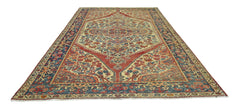 A vintage Persian Bakhtiari rug featuring a central medallion on a red and cream floral field.