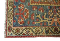 A corner view of a vintage Persian Bakhtiari rug featuring intricate floral patterns in wool.
