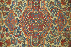A vintage Persian Bakhtiari rug featuring a geometric floral pattern in red, blue, and cream.