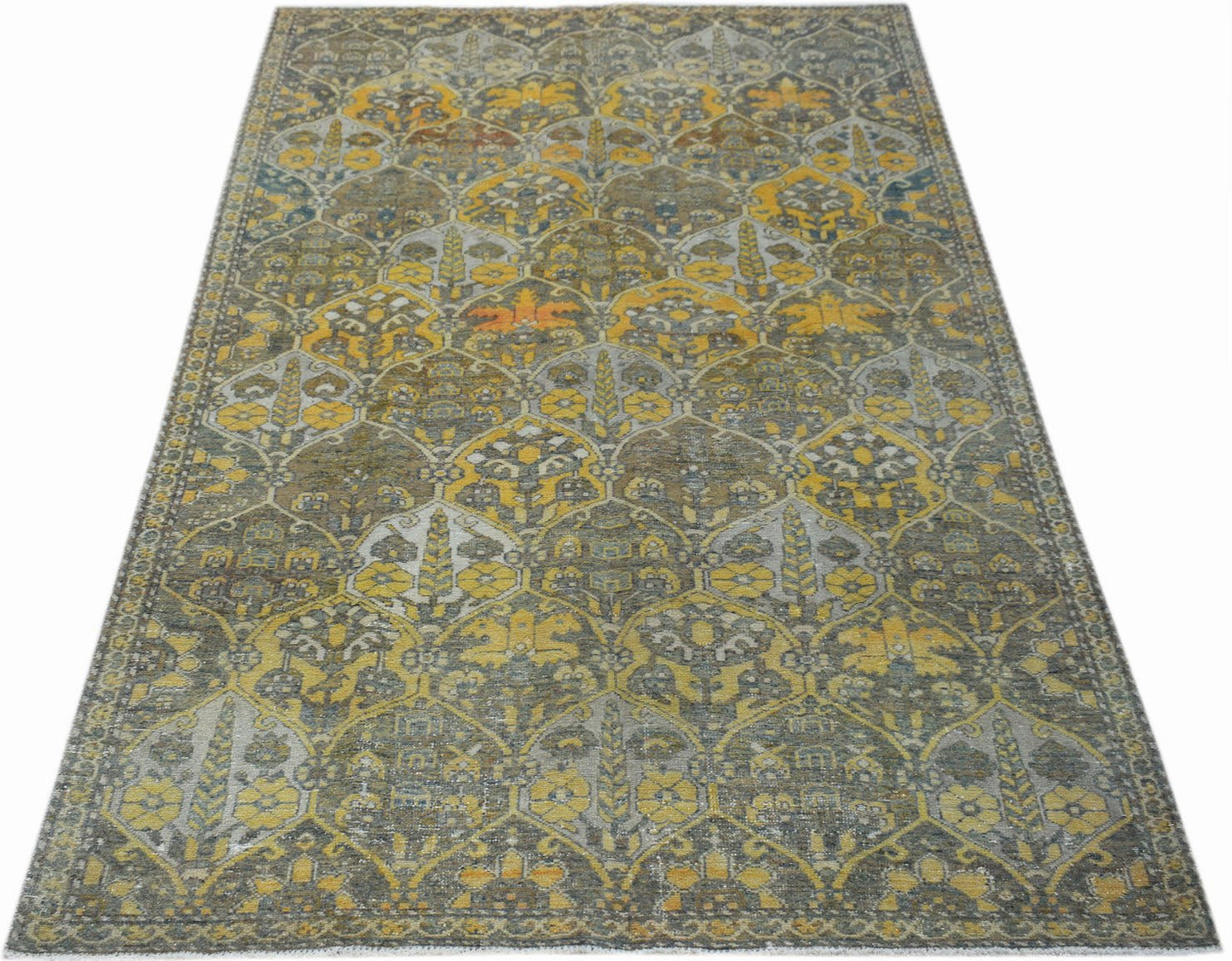 Vintage Persian Bakhtiari rug featuring a repeating floral pattern in yellow, grey, and brown.