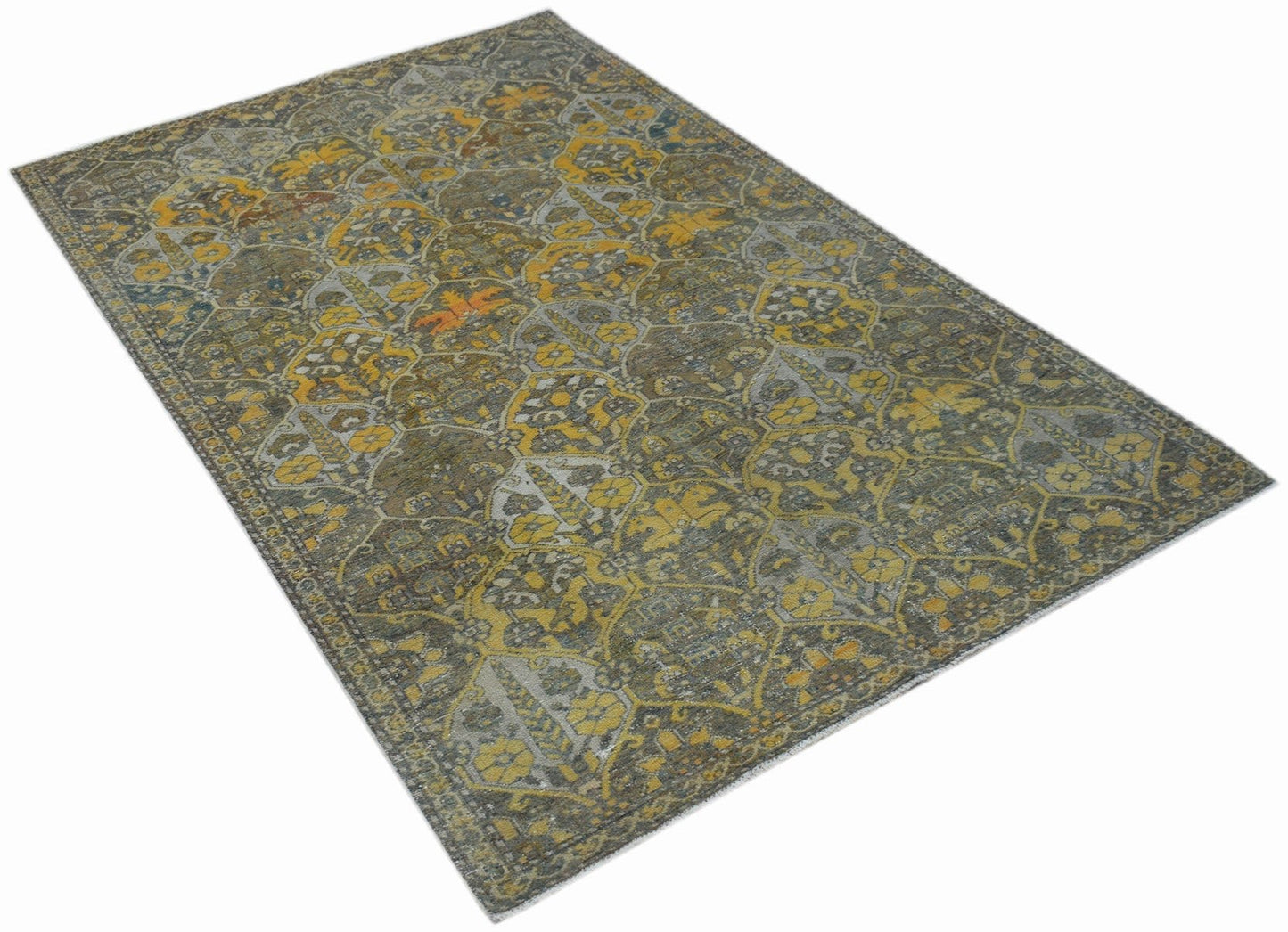 A vintage Persian Bakhtiari rug featuring a distressed floral pattern in yellow, grey, and brown.