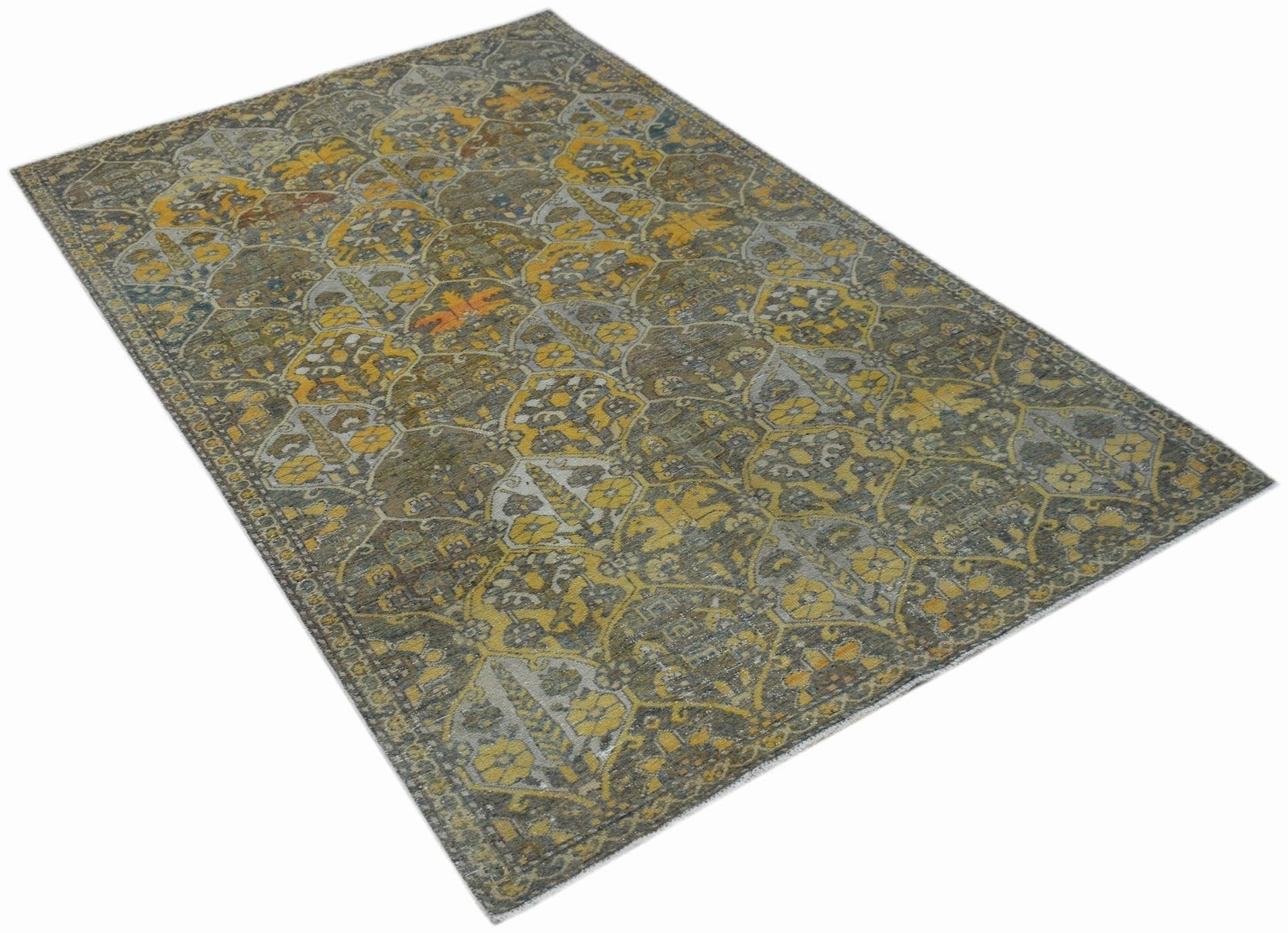 A vintage Persian Bakhtiari rug featuring a distressed floral pattern in yellow, grey, and brown.