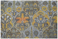 A vintage Persian Bakhtiari rug featuring a repeating geometric pattern in yellow, grey, and orange.