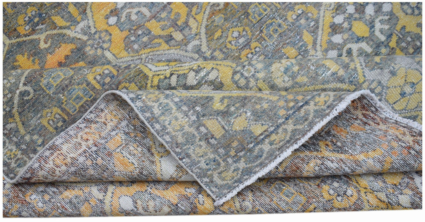 A vintage handwoven Persian Bakhtiari rug featuring a distressed floral pattern in yellow and blue.