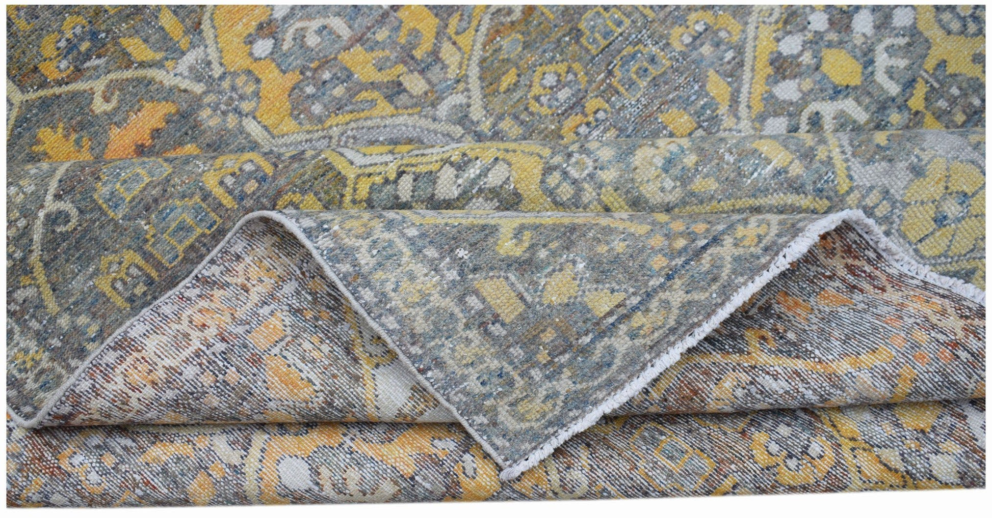 A vintage handwoven Persian Bakhtiari rug featuring a distressed floral pattern in yellow and blue.