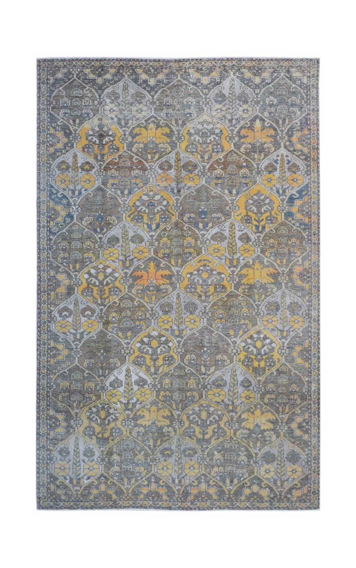 A vintage Persian Bakhtiari rug featuring a repeating floral medallion pattern in yellow and grey.