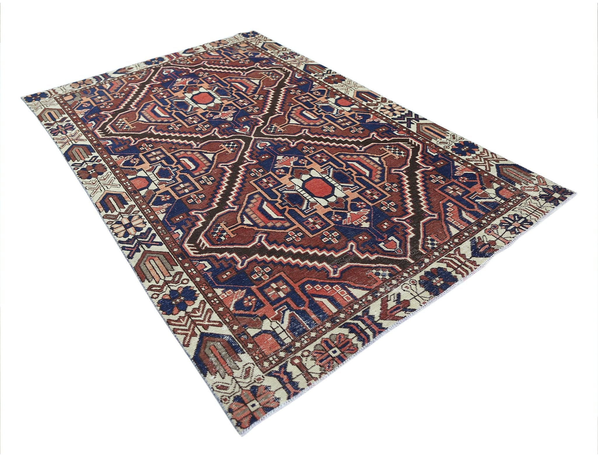 A vintage Persian Bakhtiari rug featuring a geometric medallion pattern in red, blue, and cream.