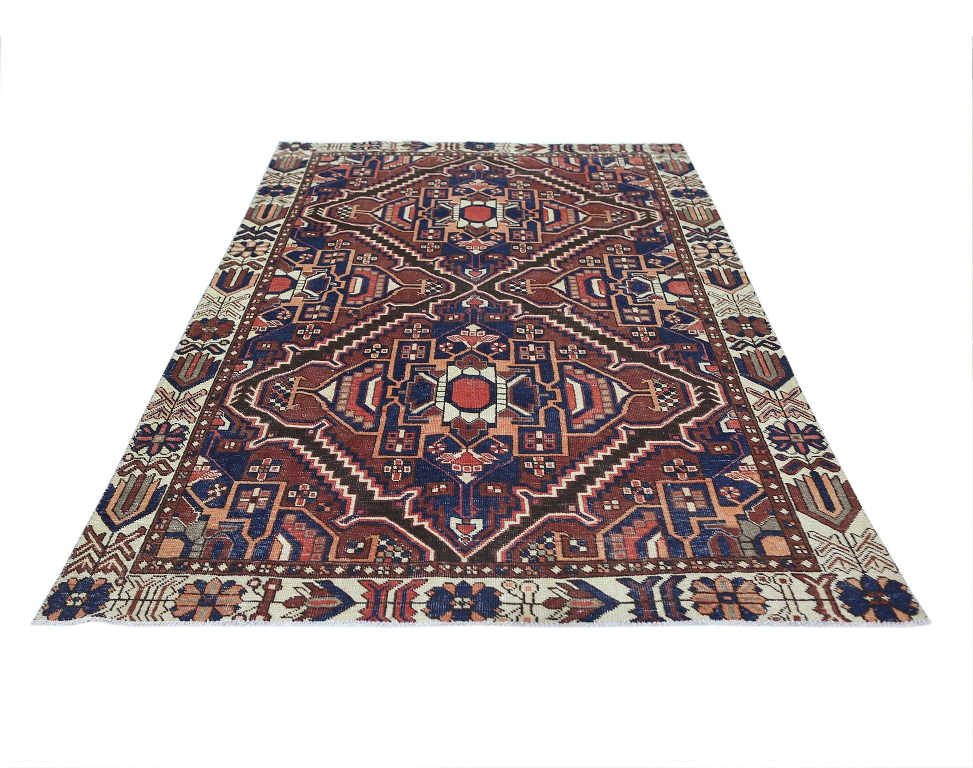A vintage Persian Bakhtiari rug featuring a geometric medallion pattern in red, blue, and cream.