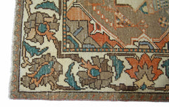 A corner detail of a vintage Persian Bakhtiari rug featuring intricate floral patterns in wool.