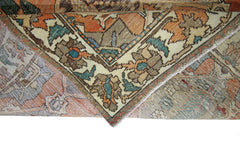A folded corner of a vintage Persian Bakhtiari rug featuring intricate floral and geometric patterns.
