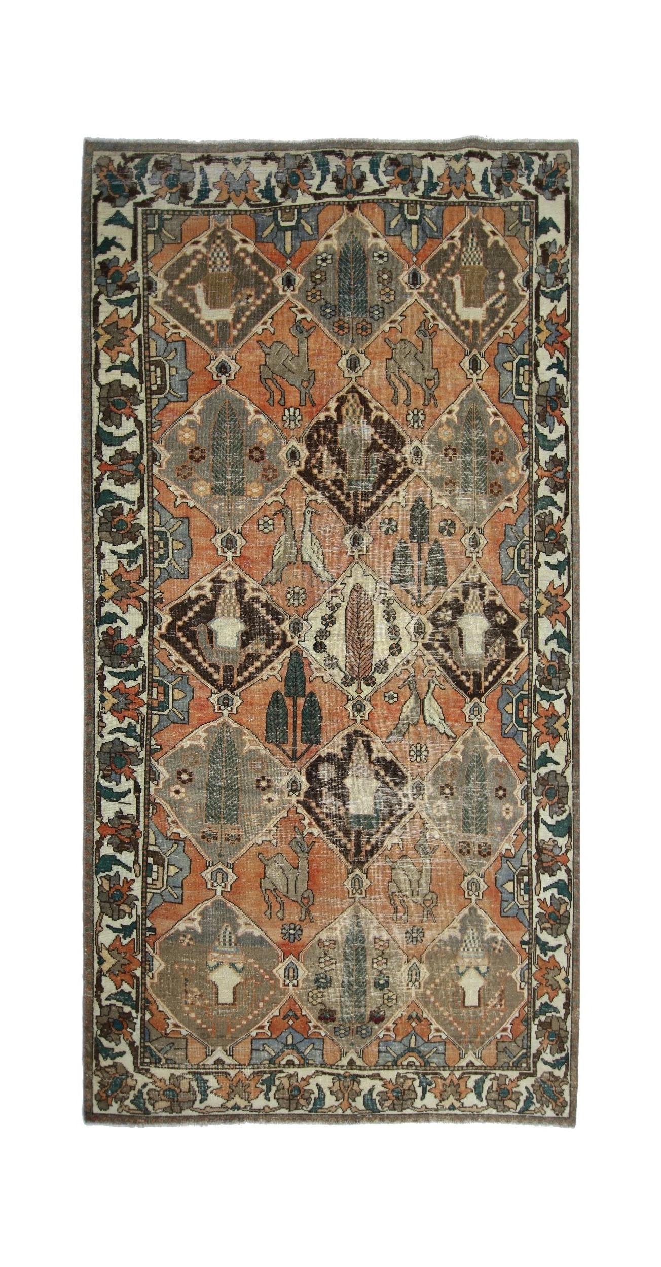 A vintage Persian Bakhtiari rug featuring a diamond lattice pattern with animal and tree motifs.
