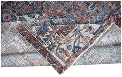 A vintage handwoven Persian Bakhtiari rug featuring a worn, intricate floral pattern in wool.