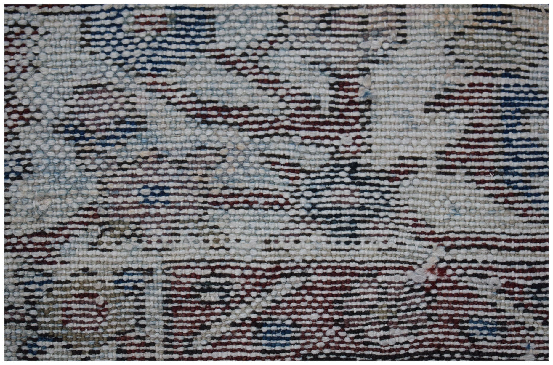 A close-up view of a vintage Persian Bakhtiari rug featuring intricate handwoven wool patterns.