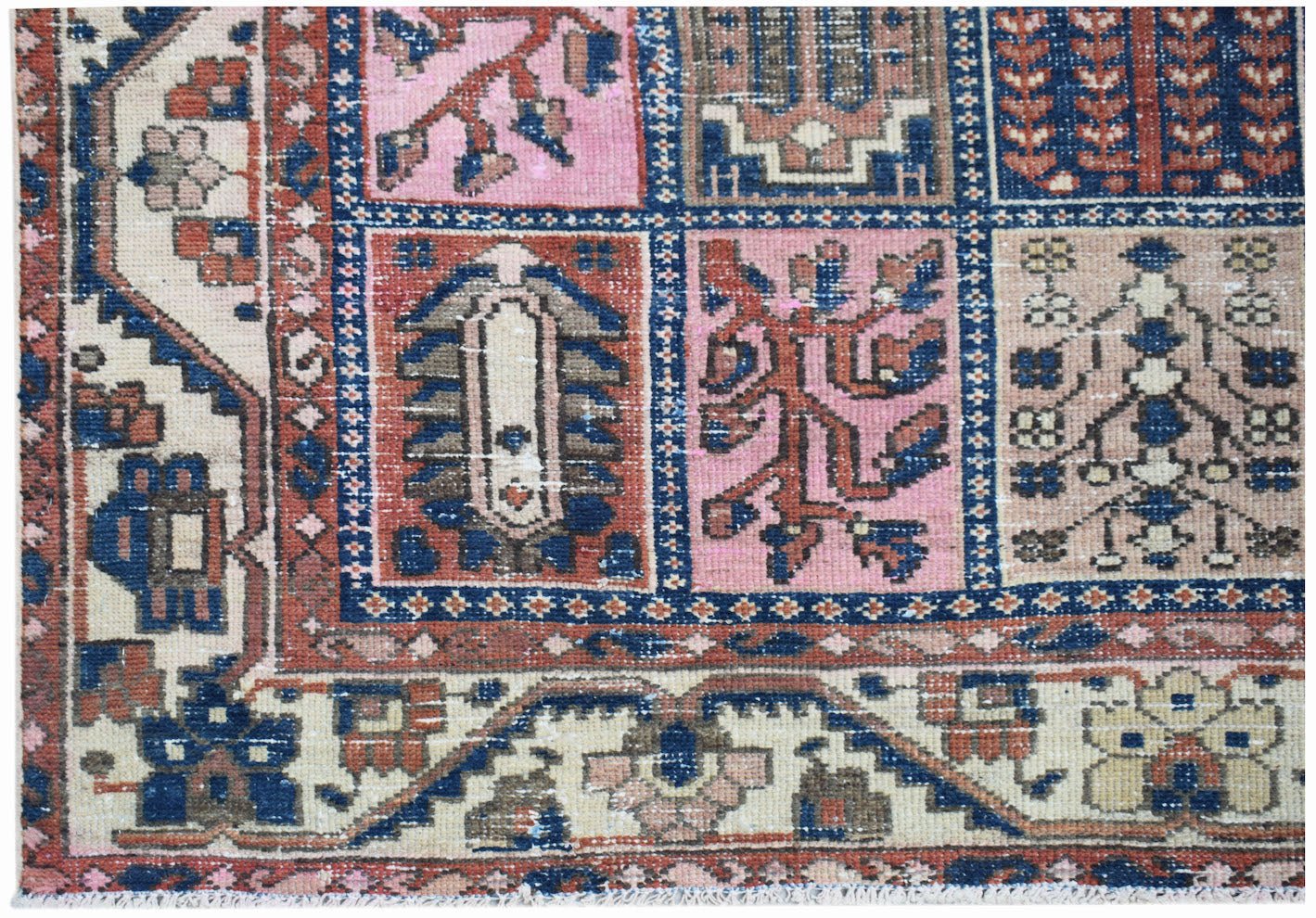 A vintage Persian Bakhtiari rug featuring a colorful geometric panel design in wool.
