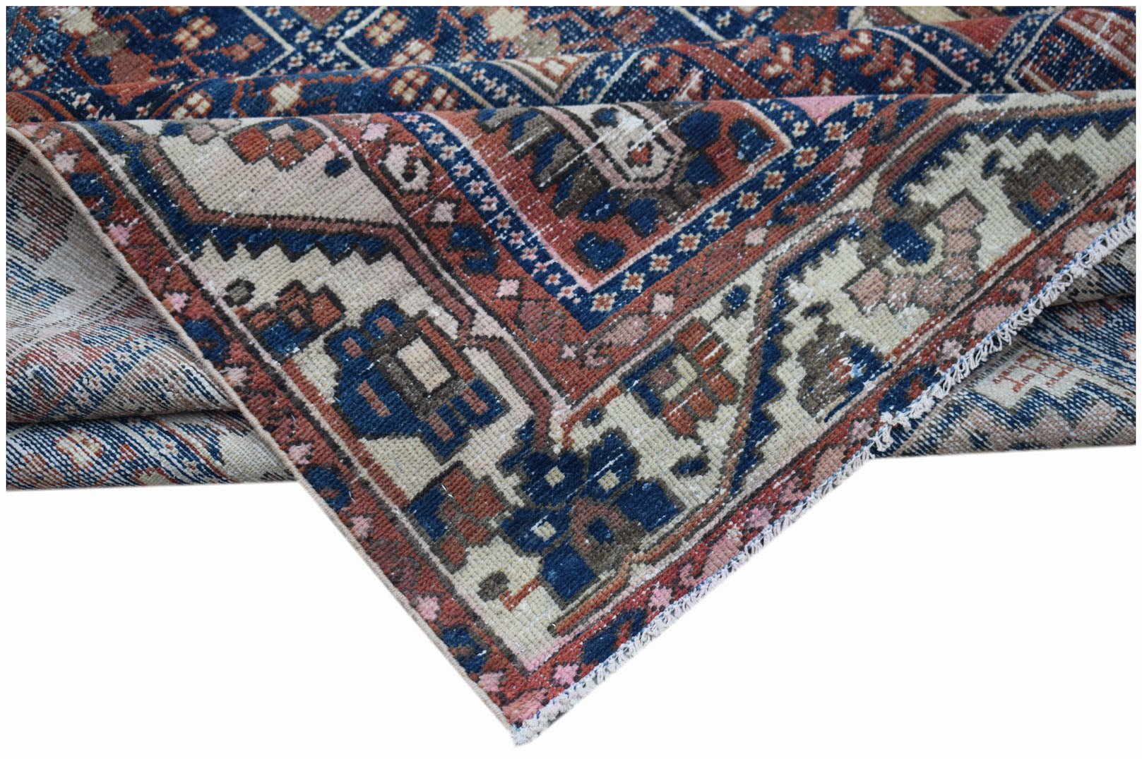 A vintage Persian Bakhtiari rug featuring a geometric pattern in blue, cream, and terracotta tones.